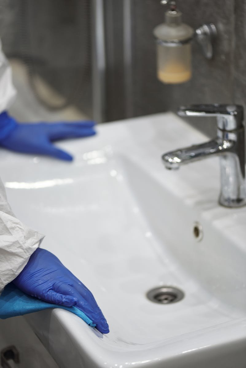 Person Sanitizes Lavatory